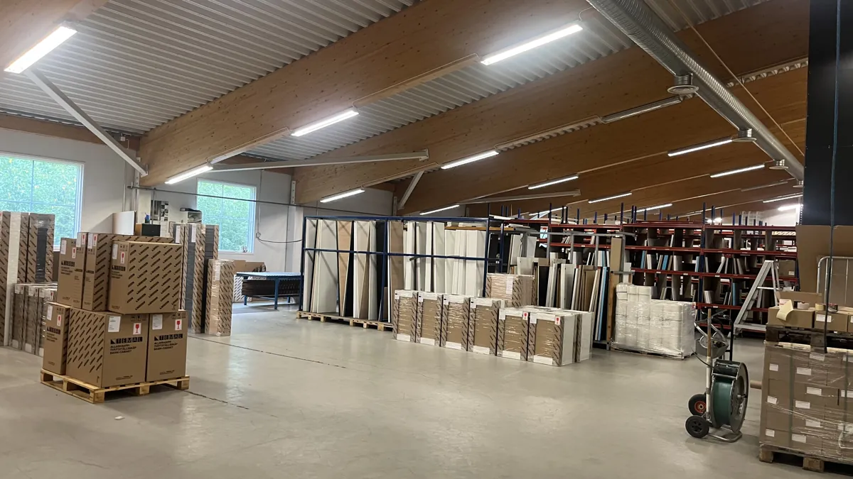 Laaja tuotantohalli, korkea puurakenteinen katto ja kattoikkunat